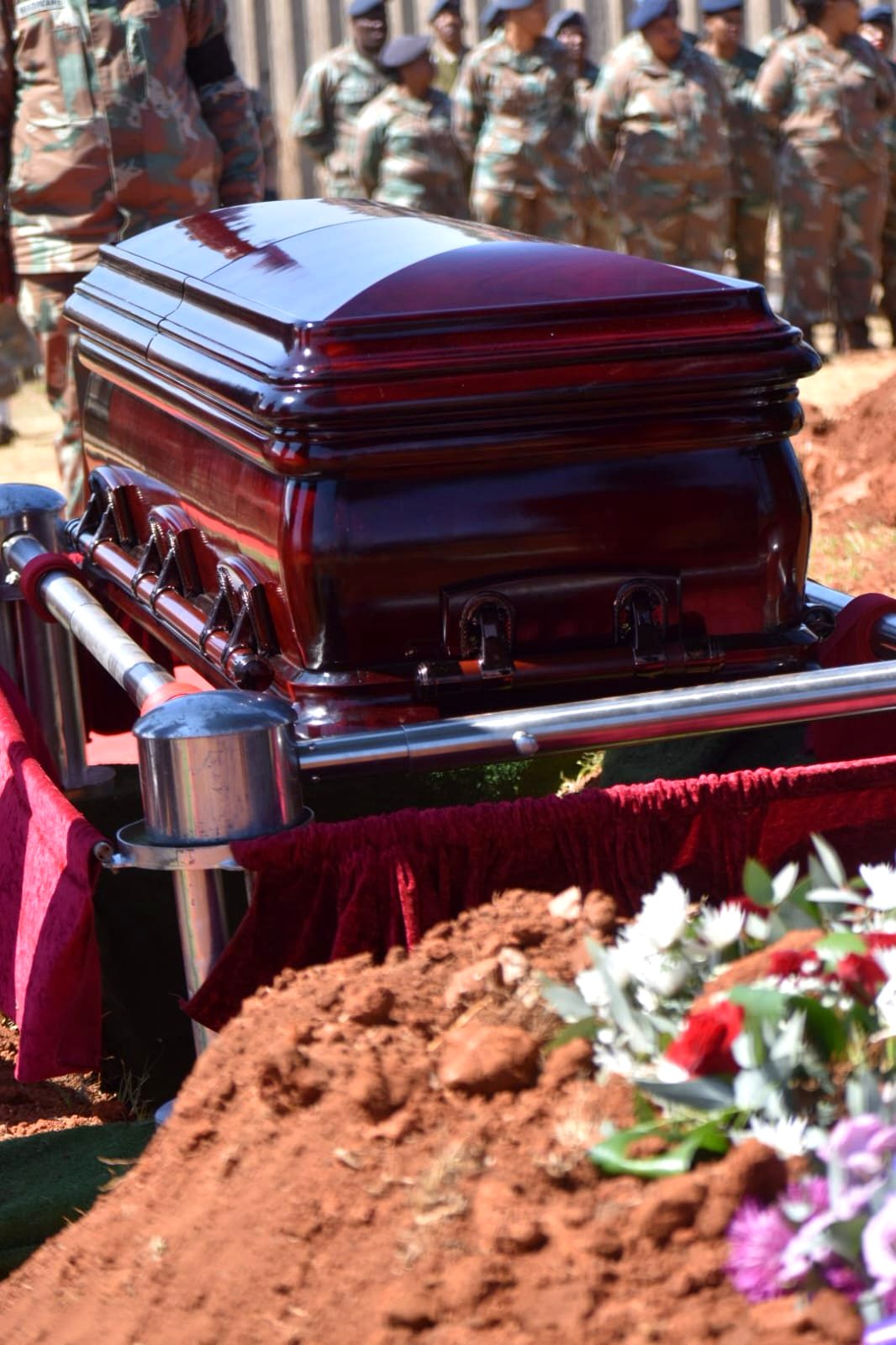 Casket on the lowering device at a Sepotokele graveside service
