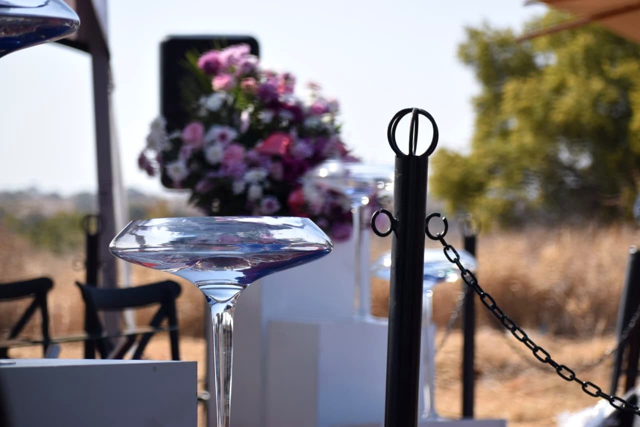 Tall glass vases with fresh floral arrangements at a service
