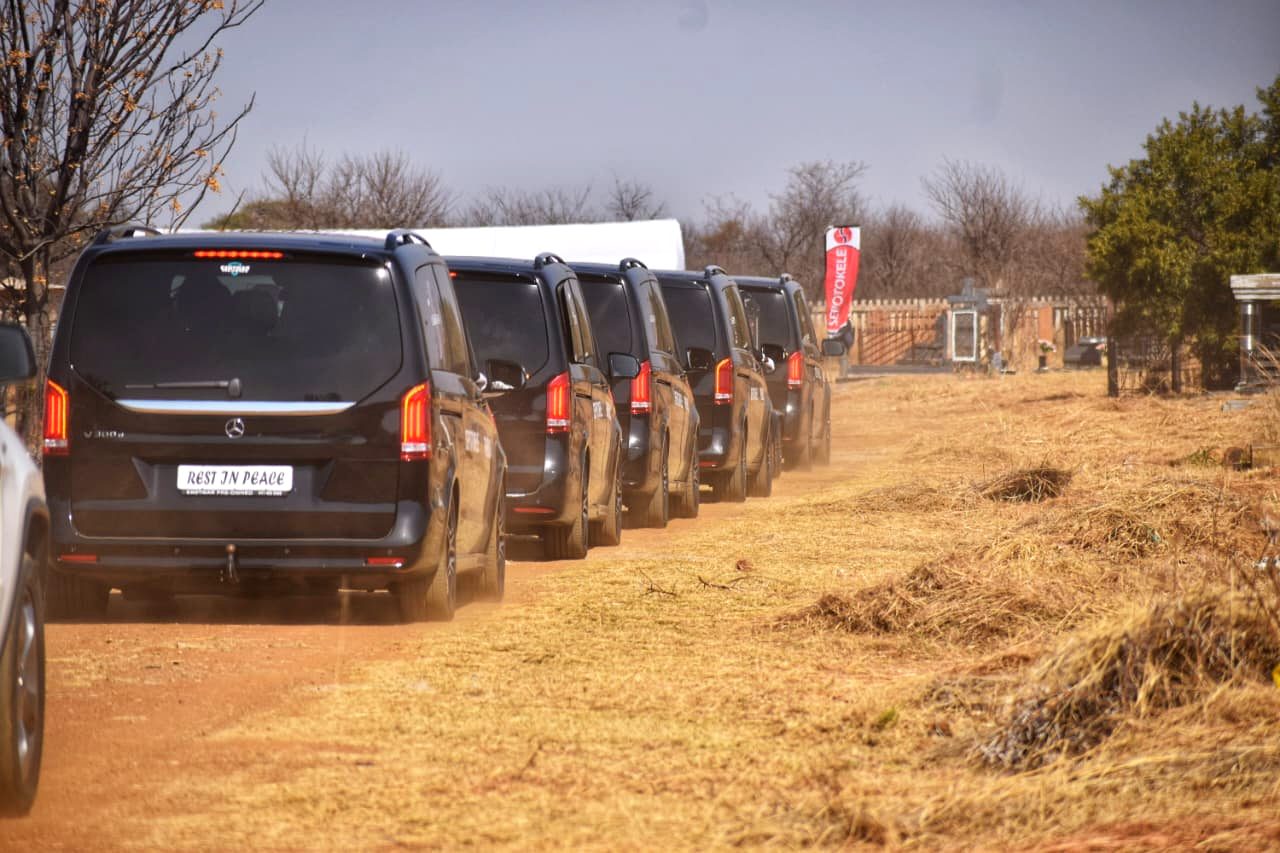 Sepotokele fleet parked at a cemetery with branded banners