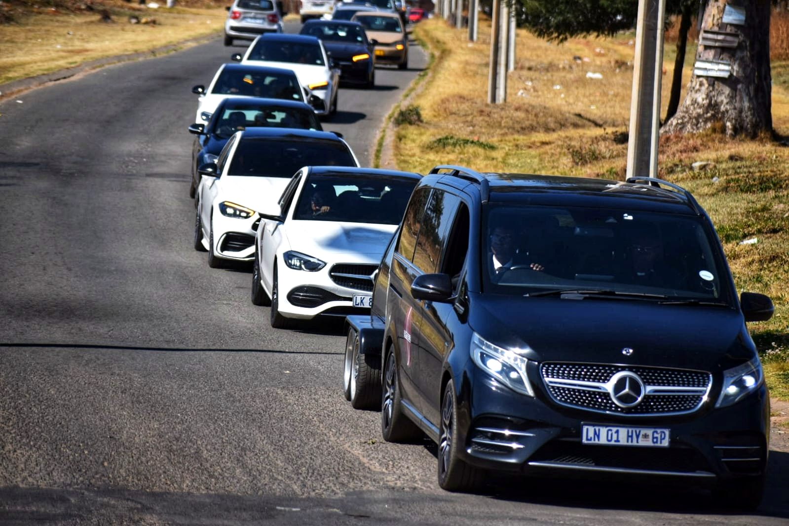 Sepotokele funeral procession led by a Mercedes-Benz V-Class and glass hearse trailer